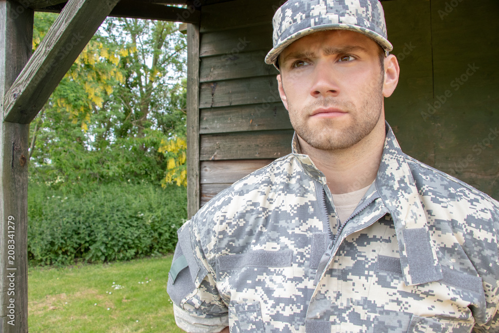 Marine, soldier in his army fatigues stands to attention at military