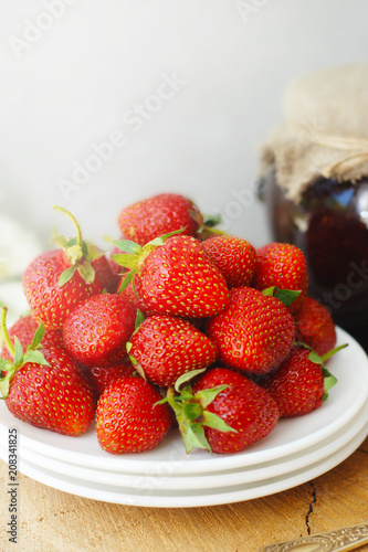 Strawberry Jam and Fresh Strawberries Textured Cement Gray Background and Jam Jar