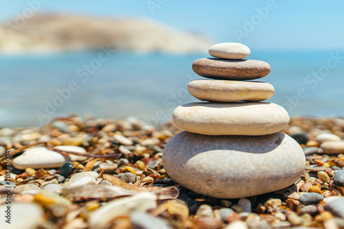 Stack of stones on the beach near sea
