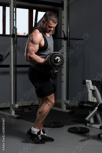 Man With Dumbbells Exercising Biceps