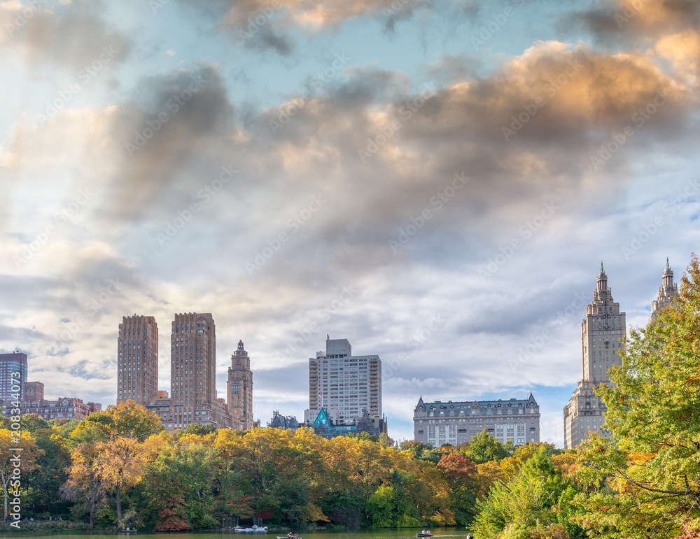 Central Park lake with reflections in foliage season, Manhattan, New York City Central Park lake with reflections in foliage season, Manhattan, New York City