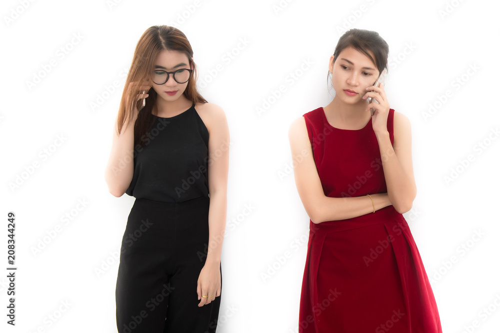 Portrait of two asian woman use of the cellphone on white background. Portrait of two asian woman use of the cellphone on white background.
