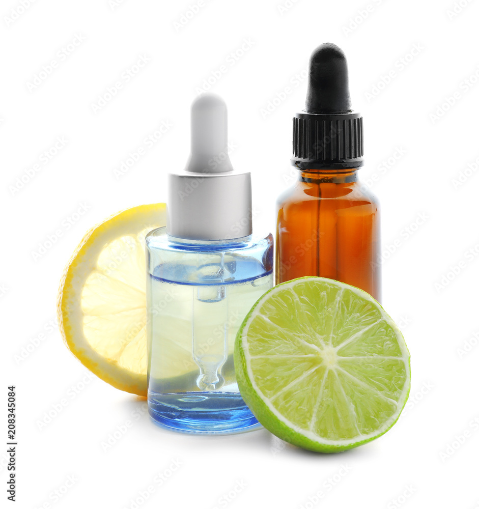 Bottles of citrus essential oil, lemon and lime on white background Bottles of citrus essential oil, lemon and lime on white background