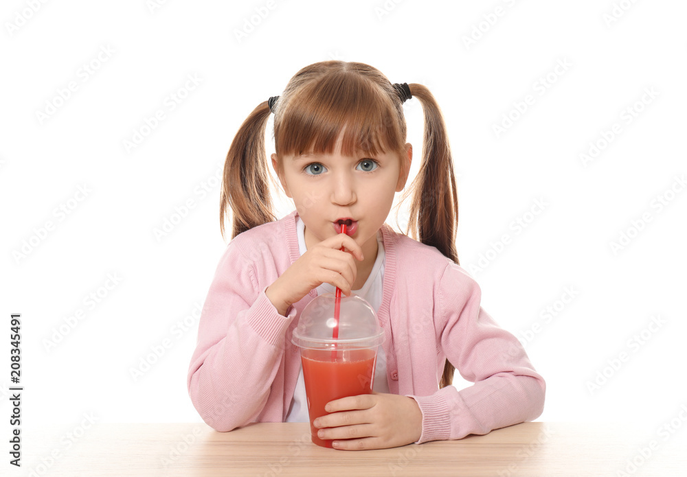 Cute little girl with citrus juice sitting at table against white background Cute little girl with citrus juice sitting at table against white background