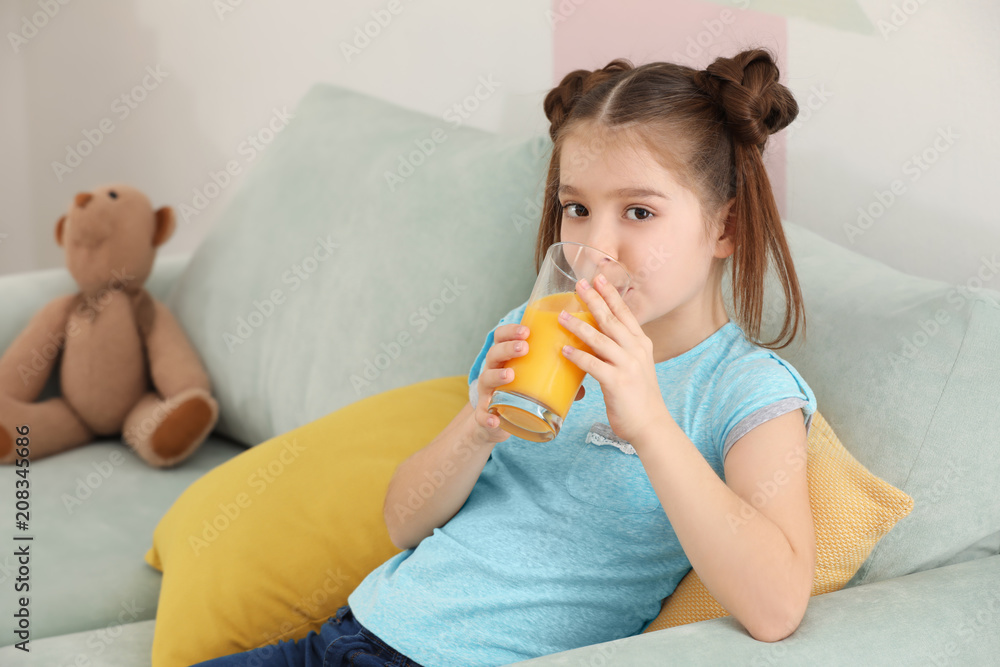 Funny little girl drinking citrus juice at home Funny little girl drinking citrus juice at home