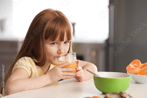 Funny little girl drinking ...