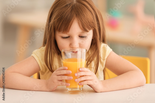 Funny little girl drinking ...