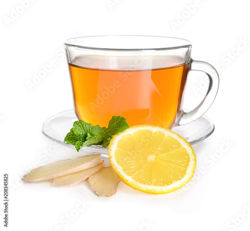 Cup of delicious tea with mint, ginger and lemon on white background