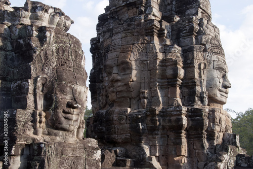 Siem Reap Cambodia, Anthropomorphic faces carved into stone at the Bayon Wat in late afternoon light, a 12th century temple within the Angkor Thom complex