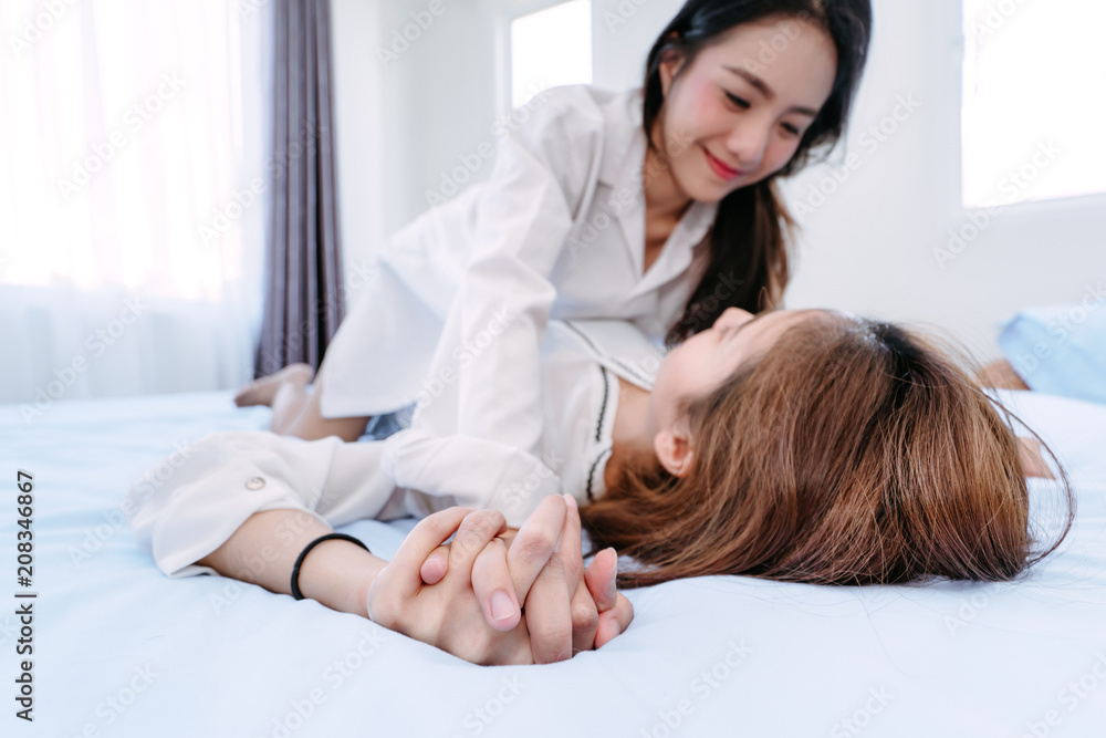 Same sex asian lesbian couple lover erotic scene in the bedroom happiness  feeling, LGBT sexuality female on bed living together at home. Stock Photo  | Adobe Stock