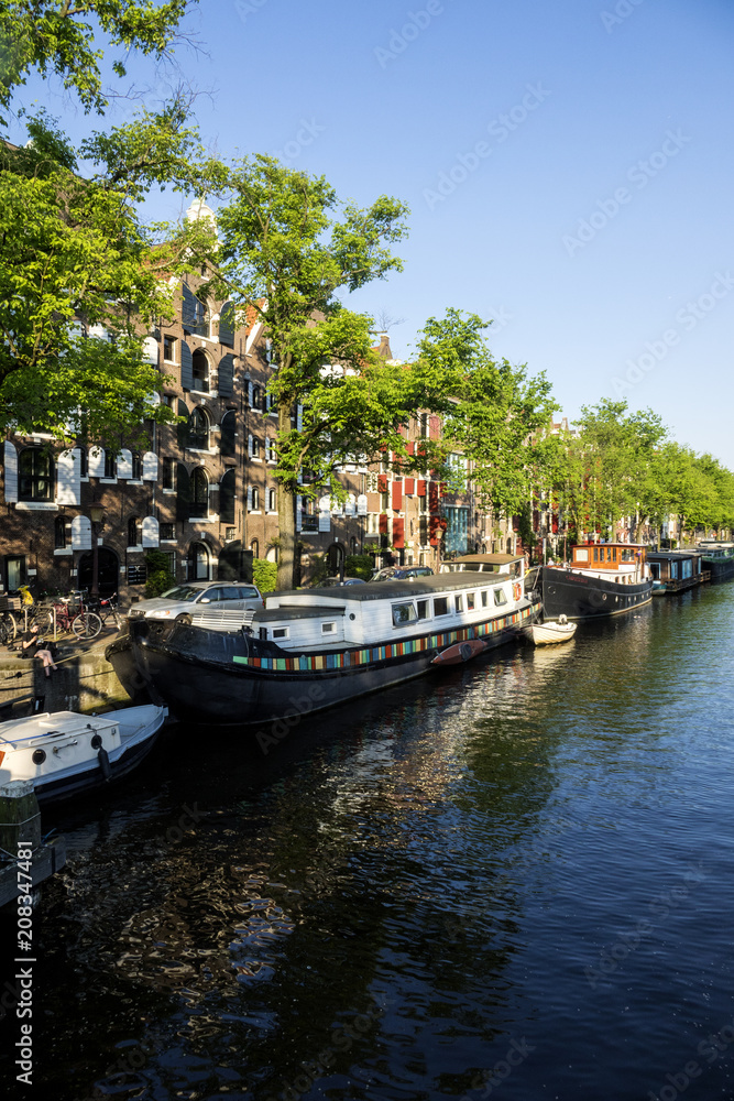 On the banks of the canals of Amsterdam, magnificent boats are transformed into houses