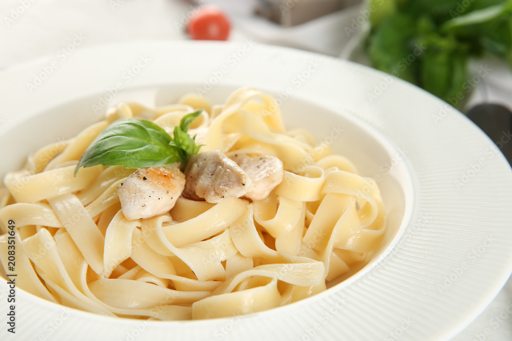 Plate of tasty pasta with chicken fillet on table, closeup Plate of tasty pasta with chicken fillet on table, closeup
