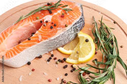 salmon steak with spices on the board