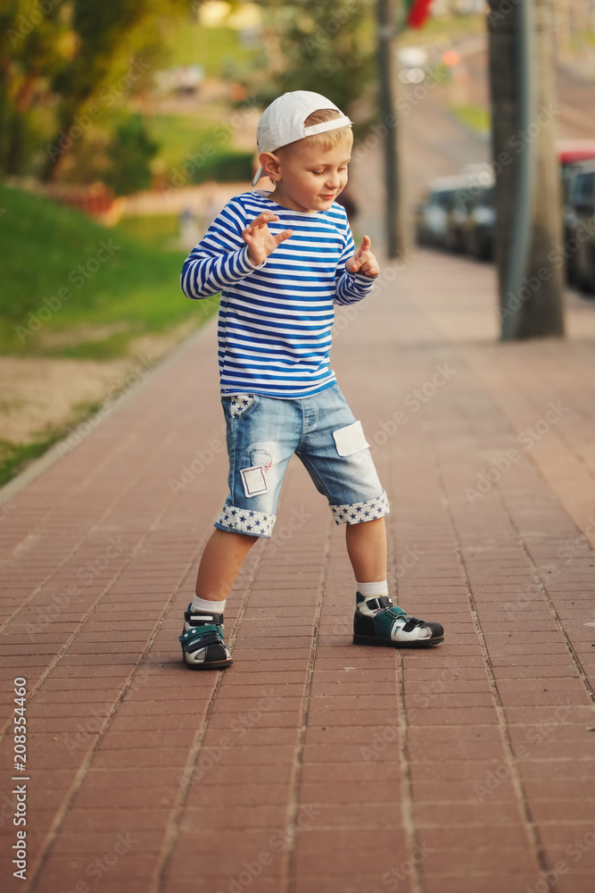 Fototapeta premium little boy dancing on the street