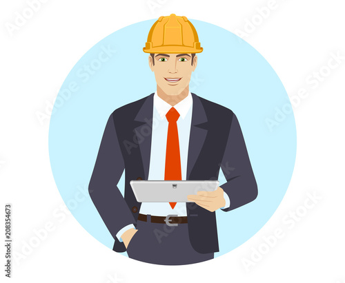 Businessman in construction helmet holding digital tablet PC