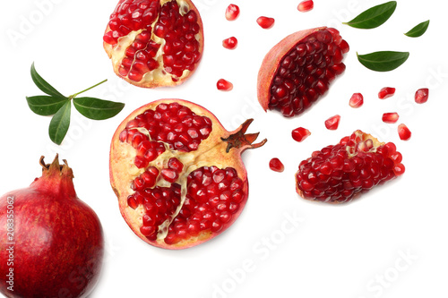 pomegranate fruit with green leaves isolated on a white background top view