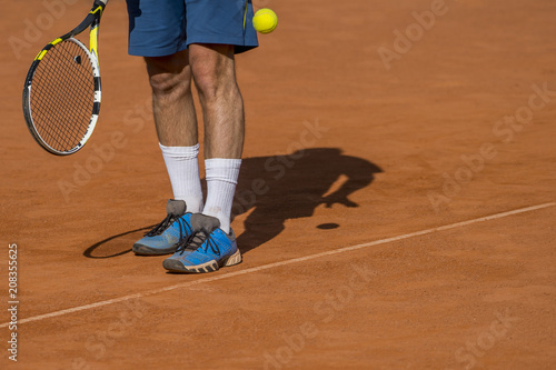 The tennis player puts the ball © Augustas Cetkauskas