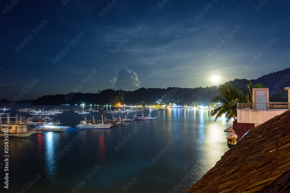 Boats in the El Nido harbor at night - Palawan, Philippines. Night landscape