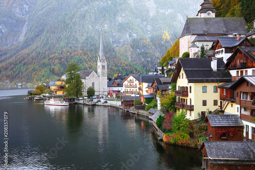 Scenic view of famous Hallstatt mountain village with Hallstatter lake See in beautiful golden morning light in fall