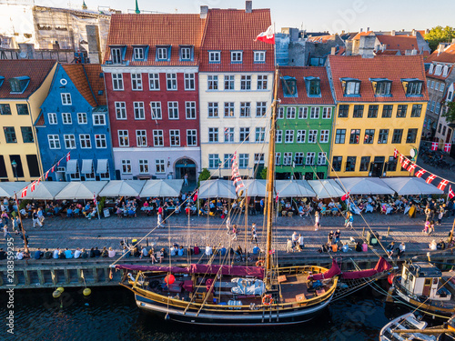 Cozy famouse colorful houses Nyhavn New Harbour canal and entertainment district in Copenhagen, Denmark. Street on the canal. Aerial view from the top. historical wooden ships