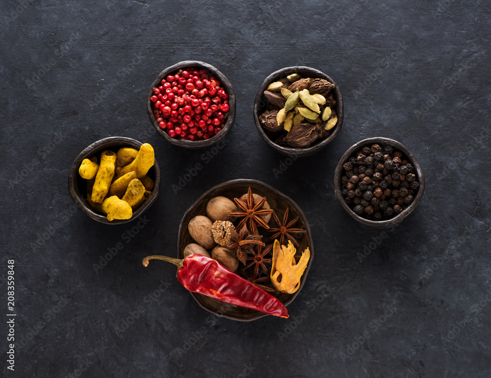 Spice, spicy and seasoning in bowls on a black background Spice, spicy and seasoning in bowls on a black background