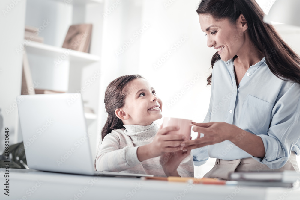 Take it. Beautiful female person expressing positivity while looking at her daughter Take it. Beautiful female person expressing positivity while looking at her daughter