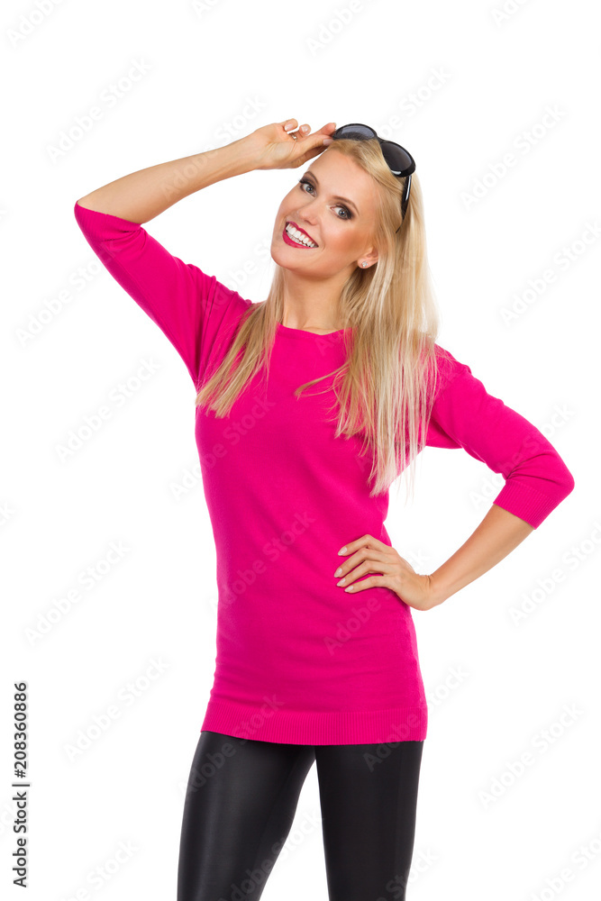 Beautiful Woman Is Holding Sunglasses On Head, Looking At Camera And Smiling Beautiful Woman Is Holding Sunglasses On Head, Looking At Camera And Smiling
