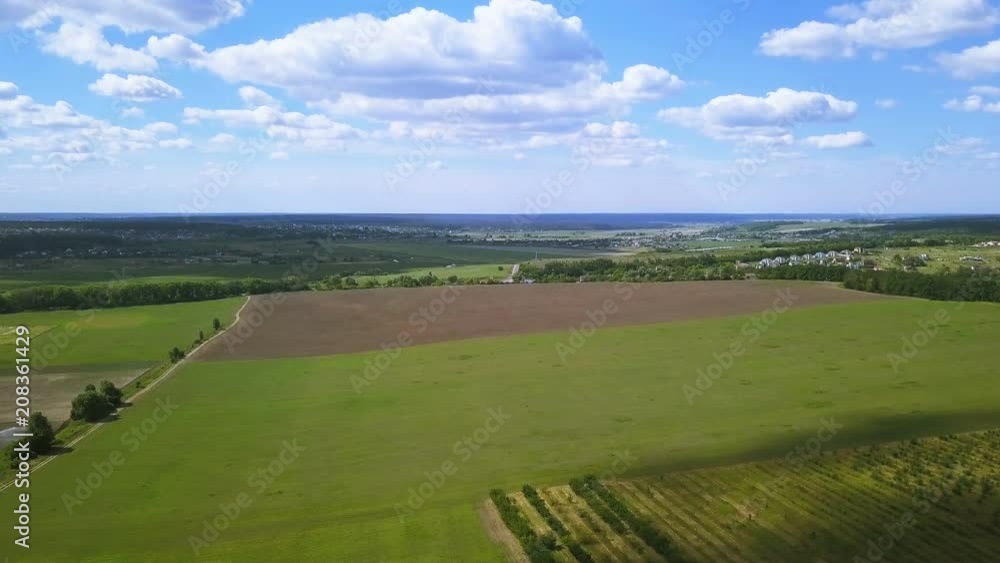 4K Aerial. Fly over spring green fields, sky and clouds . Agricultural landscape 4K Aerial. Fly over spring green fields, sky and clouds . Agricultural landscape