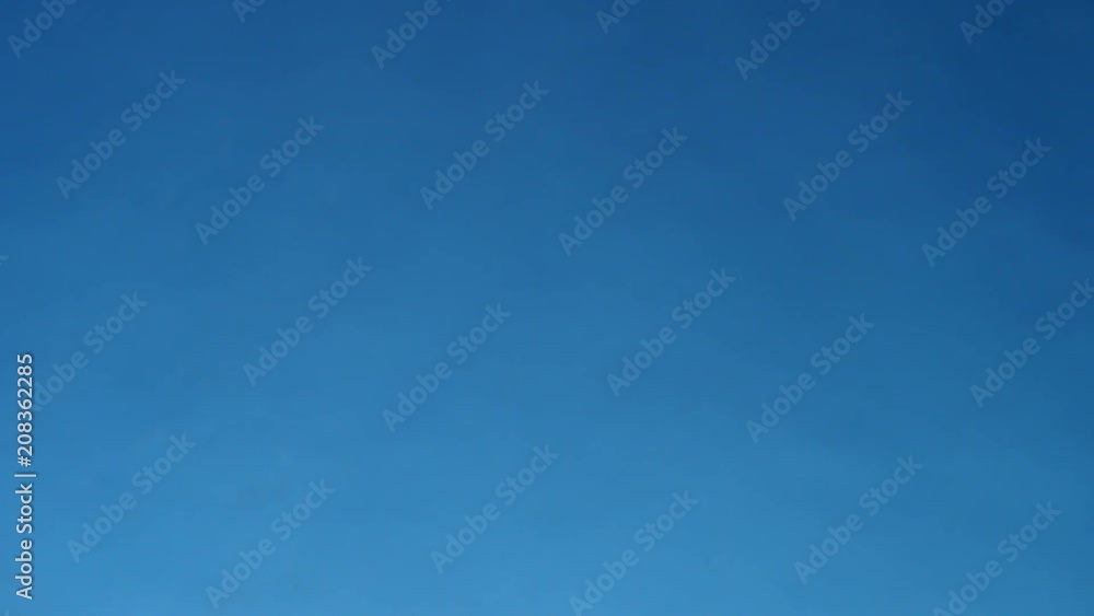 hands of Young man plays jenga on blue background, close-up. A man builds a tower of blocks while playing jenga