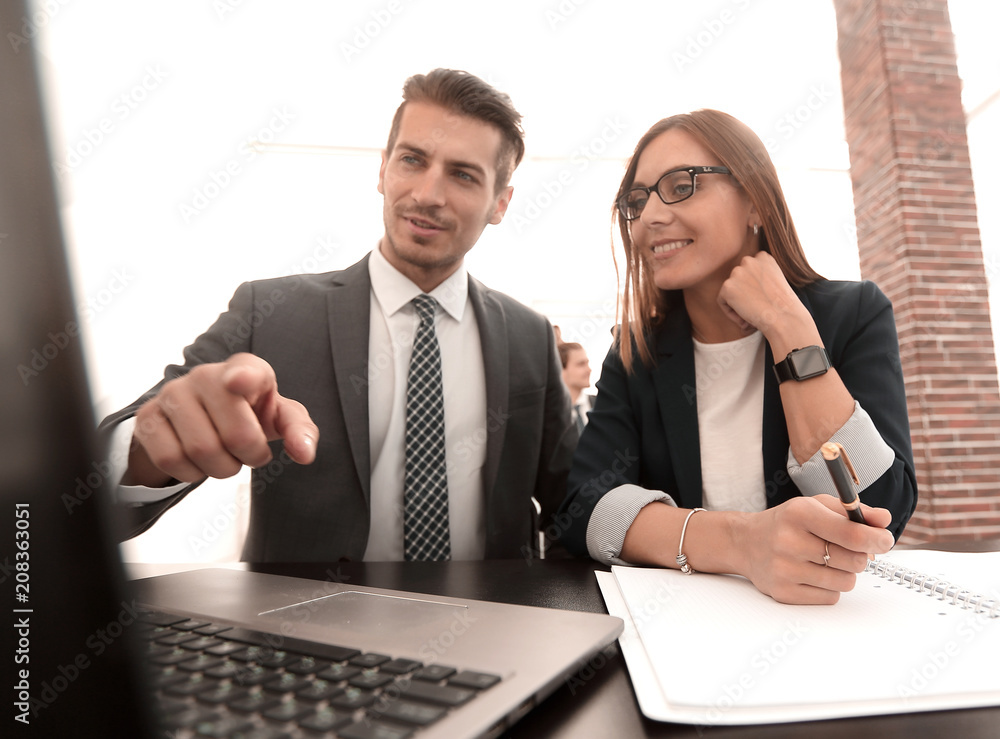 Two successful partners working with a laptop Two successful partners working with a laptop