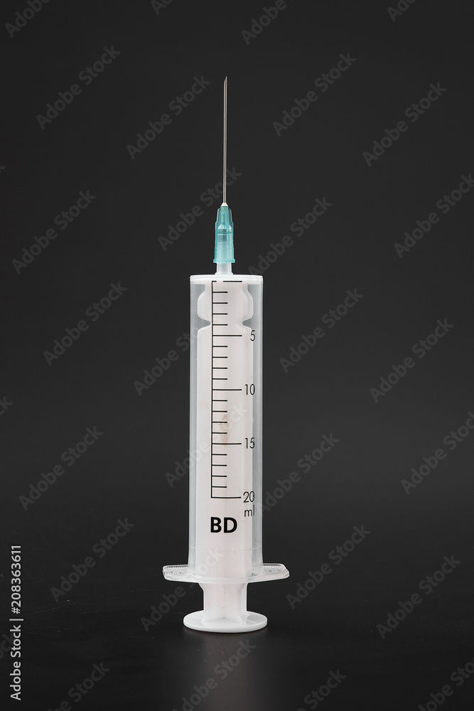 medical syringe with needle on black background. medical syringe with needle on black background.