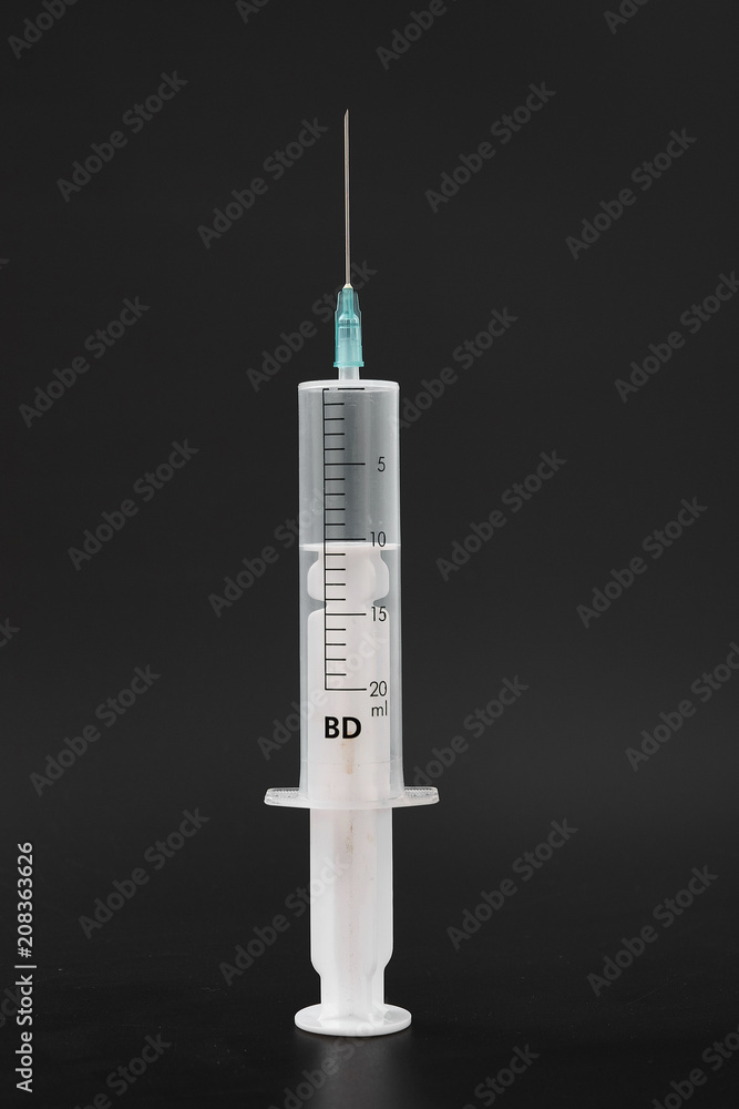 medical syringe with needle on black background. medical syringe with needle on black background.