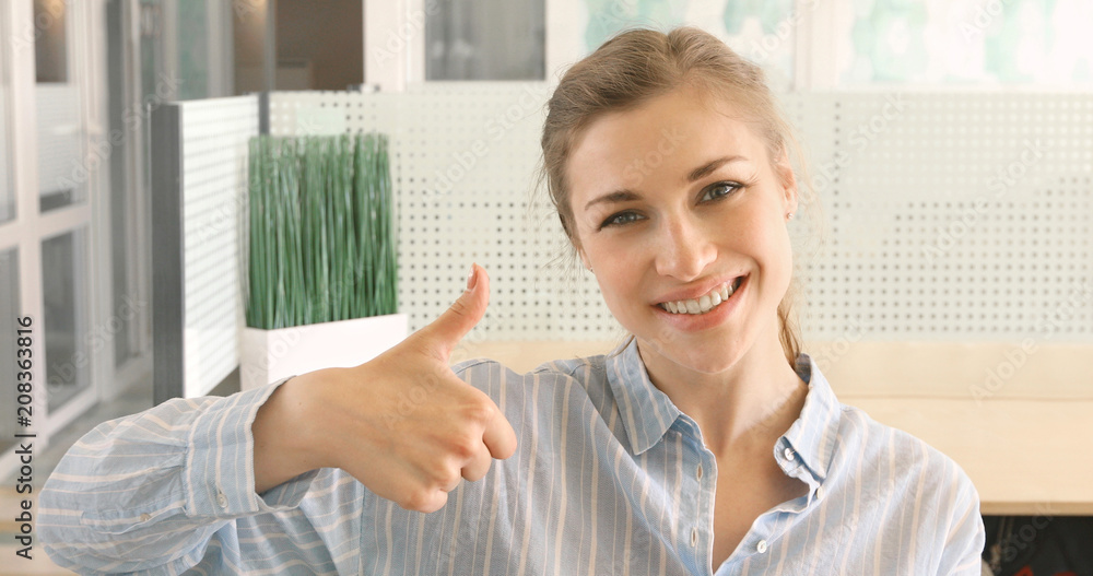 Cheerful girl showing thumb up smiling. Woman smiles shows good gesture Cheerful girl showing thumb up smiling. Woman smiles shows good gesture