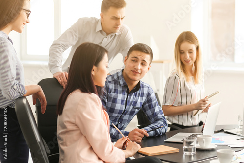 Young people having business meeting in office