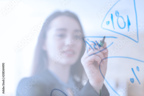 Young woman giving presentation during business meeting in office