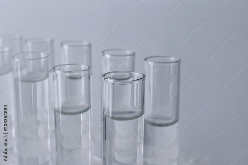 Test tubes with water on light background Test tubes with water on light background