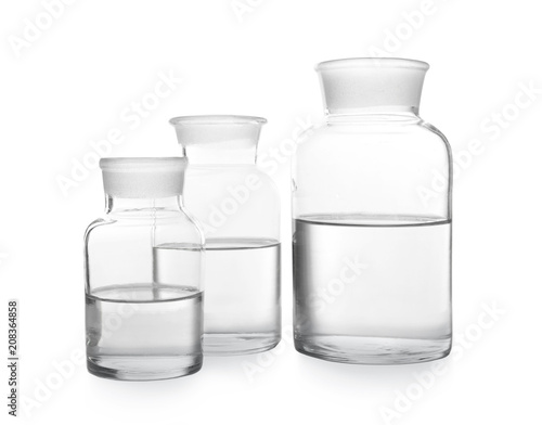 Glass bottles with water on white background