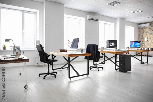 Office interior with tables and armchairs. Workplace design