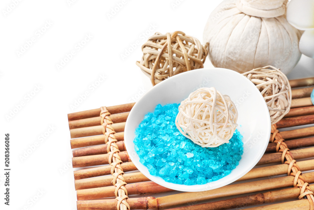 Bowl with sea salt for spa procedures on white background