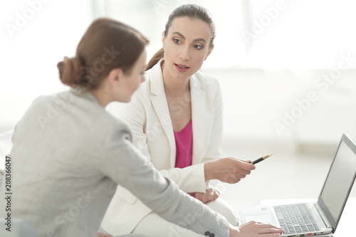 two women designers working on laptop © ASDF