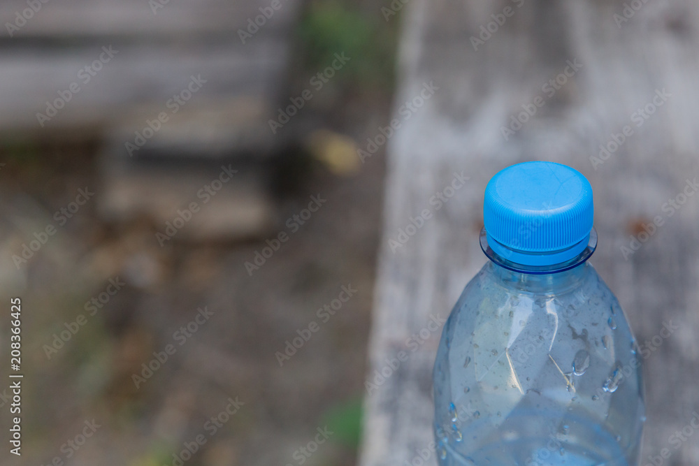Plastic bottle with water on a wooden background. Plastic bottle with water on a wooden background.