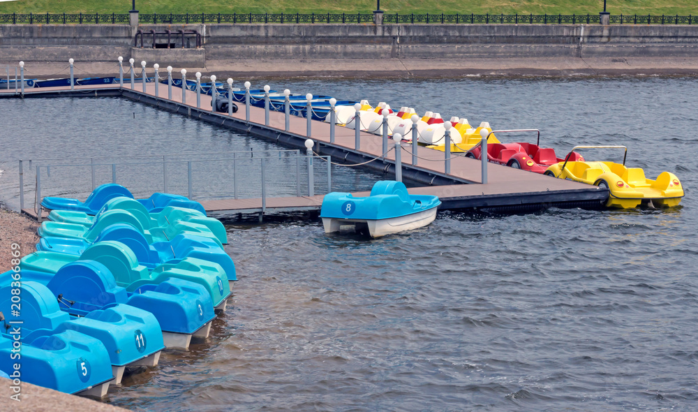 Cute colorful car catamarans on the lake in the park