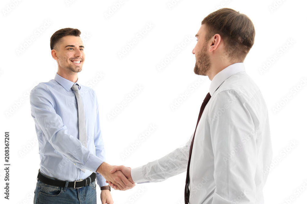 Two young men shaking hands on white background