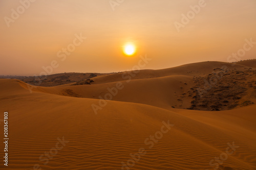 Sunset and amazing landscape of Red Sand Dunes in south Vietnam near to Mui Ne fishing town.