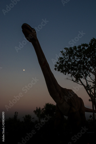 Silhouette of dinosaurs in the sunset. © thanongsak