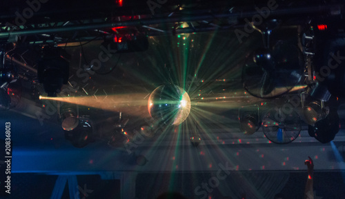 Mirror ball in a nightclub with different lights.