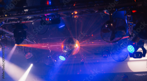 Mirror ball in a nightclub with different lights.