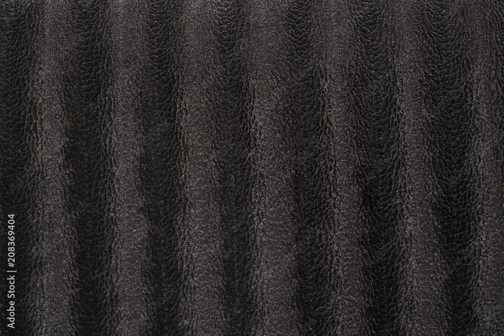 A black velour cloth with snake inspired animal skin patterns boasting a highly detailed texture with an intricate design and a velvety softness exuding both elegance and a hint of the wilderness.