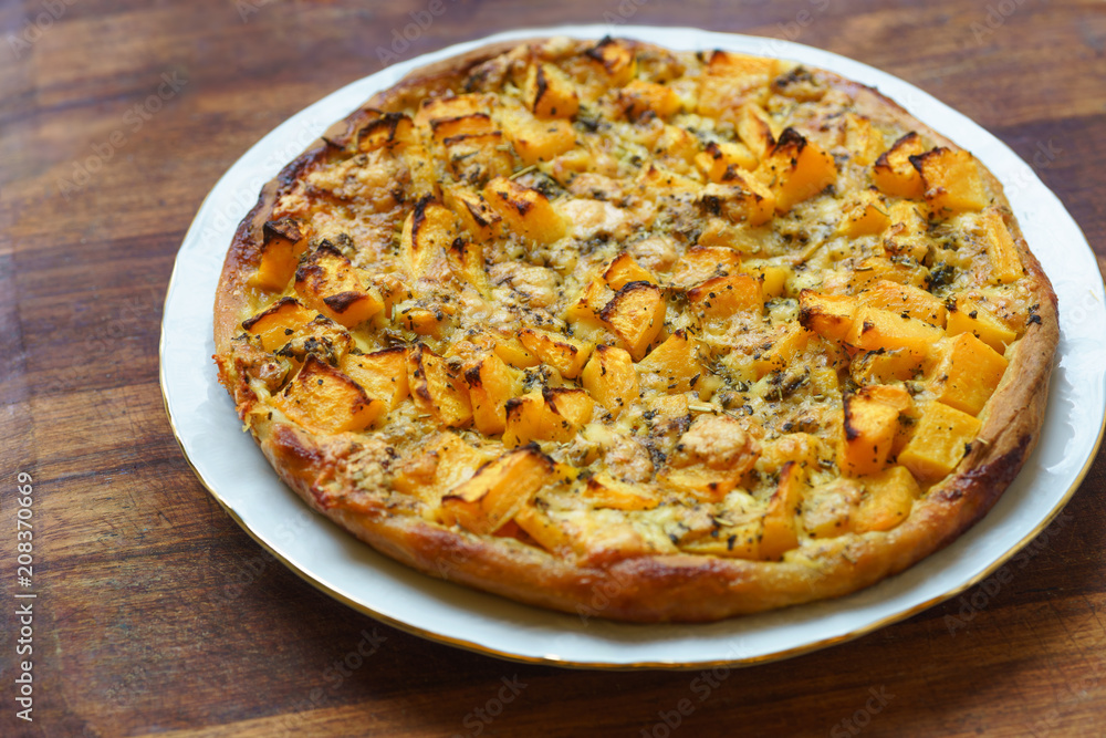 Pizza with pumpkin on wooden background Pizza with pumpkin on wooden background