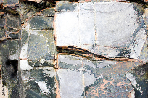 Aged stone with moss and cracks. Rock painting of deer at the bottom. Natural background